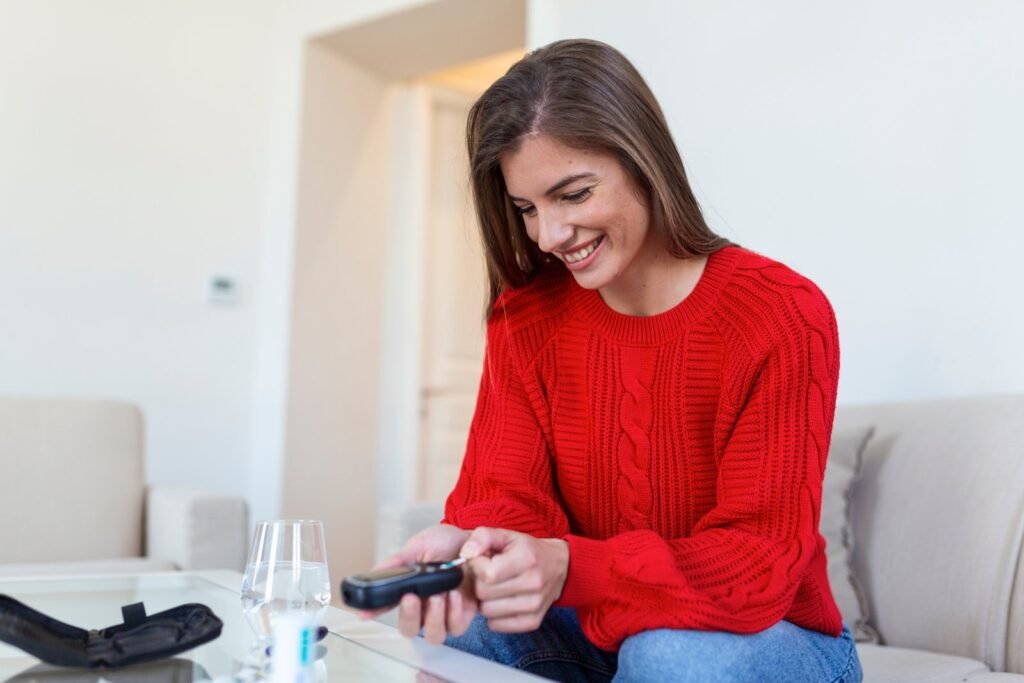 Woman checking her blood glucose with a finger-prick blood sugar test at home